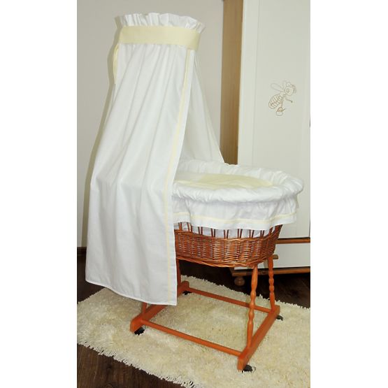 Wicker cot with white and cream set bedding