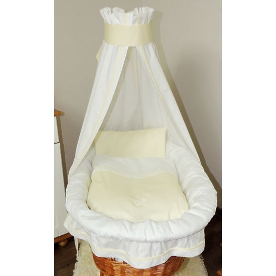 Wicker cot with white and cream set bedding