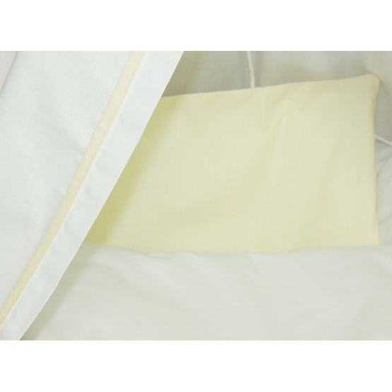 Wicker cot with white and cream set bedding