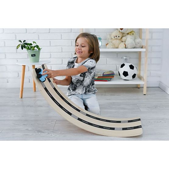 Wooden balance board with toy car and road